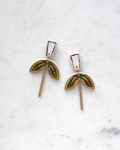 Inspired by the beautiful shape of a Dragonfly, these double dangle Florri earrings are a definite nod to art deco design.  Handmade in white porcelain, they have been glazed with a deep olive green and then decorated with 22ct gold lustre. A recycled brass bar hangs from the bottom section.  - Size: Extra Large - Lightweight at just 8 grams - Measures 30mm wide x 60mm long - 925 sterling silver earring post - Natural clay / plastic free - Kiln fired and hardwearing - Free Royal Mail 2nd Class for UK orders (upgrades available) - Packaged on a branded card & tissue wrapped - Handmade by me, an independent crafter, in my Yorkshire studio Please note that as a handmade item, each piece will vary slightly. ~ Care Instructions ~ To keep jewellery looking its best simply wipe over porcelain wit Unique White Enamel Earrings, Art Deco Hardware, Hardware Cloth, Porcelain Earrings, Ceramic Earring, Art Deco Inspired, 925 Sterling Silver Earrings, Keep Jewelry, Art Deco Design