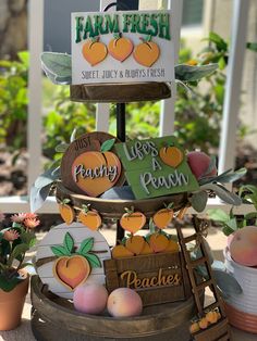 an assortment of fresh fruit is displayed on a stand in front of some potted plants