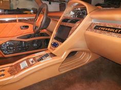 the inside of a car with leather and wood trim