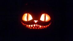 a jack o lantern with glowing eyes in the dark