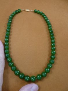 (Internal #V-308-12a) You are bidding on a beautiful, handmade, necklace made with light Green Jade round 10 mm beads. Necklace is 18" long, with gold safety closure.  WE SHIP WORLDWIDE!  Other accepted payment: Credit card (Mastercard/Visa/Discover) inquire for details. Classic Beaded Necklaces With 8mm Round Beads, Classic Beaded Necklace With Large Beads, Classic Jade Necklaces With Round Beads, Jade Beaded Necklace With Polished Beads, Classic Jade Necklace With Round Beads, Classic Round Beaded Necklace With Polished Beads, Classic Polished Beaded Necklace, Classic Round Polished Beaded Necklaces, Classic Round Polished Beads