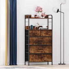 a tall wooden cabinet sitting next to a lamp on top of a hard wood floor