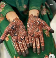 the hands are decorated with henna designs