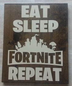 a sign that says eat sleep fortnite repeat on the side of a wall