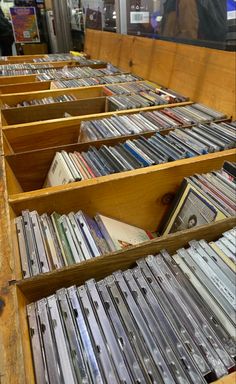 an old wooden box filled with lots of cd's on display in a store