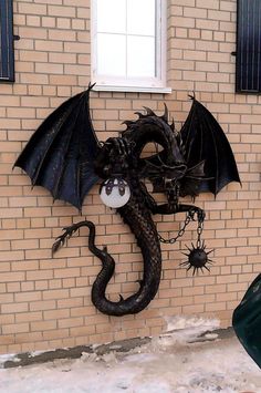 a black dragon statue on the side of a building