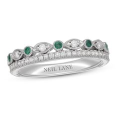 a wedding band with diamonds and emeralds