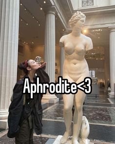 a woman standing next to a statue with the words aphrodite - 3 on it