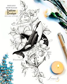 an orca whale tattoo design next to some flowers and a candle on a table