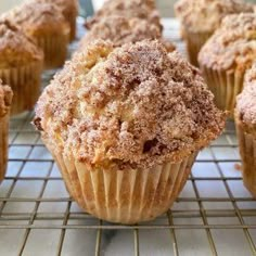 muffins with powdered sugar on top cooling on a rack