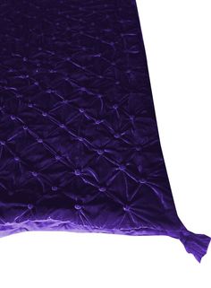 a purple blanket is laying on the floor