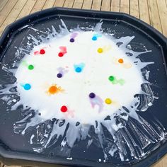 a black tray with white paint splattered on it