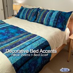 a bed with blue and white bedspread in a bedroom next to a night stand