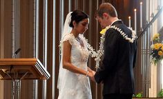 a bride and groom standing in front of a alter during a wedding ceremony at a church