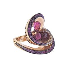 a pink and purple diamond ring with two hearts on the front, set in 18k yellow gold