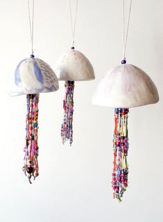 three different types of beads hanging from strings