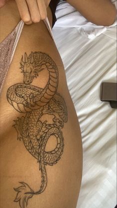 a woman with a dragon tattoo on her stomach