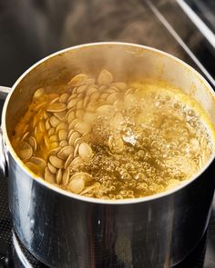 a pot filled with food sitting on top of a stove next to a burner