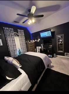 a bed room with a neatly made bed and a flat screen tv on the wall