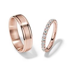 two rose gold wedding rings with diamonds on each side and one in the other's band