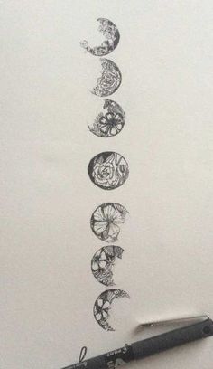 an ink drawing of five phases of the moon and stars on a sheet of paper