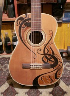 a wooden guitar with an intricate design on it