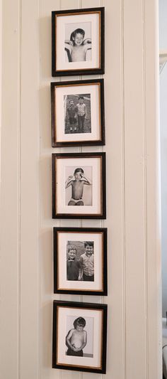 black and white photos hanging on the wall