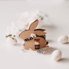 an easter decoration made out of cardboard with eggs and flowers on the table next to it