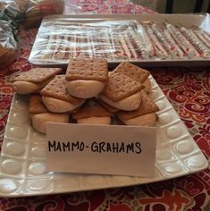 some cookies are on a white plate and there is a sign that says mamo - grahams