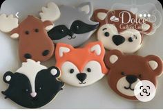 four decorated cookies in the shape of animals