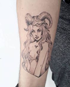 a woman with long hair and horns on her arm