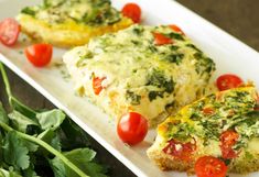 two pieces of quiche on a plate with tomatoes and parsley