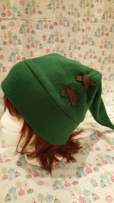 "Comes in green or olive green - please specify the color you want when ordering! Perfect for wearing during Halloween, conventions, cosplay, skiing/snowboarding, cold winter nights, or just for fun! Cute and comfortable! This hat is Adult sized - approximately 23\" around. For cleaning please spot clean only. Gentle hand wash if absolutely necessary. Need a different size? I take commissions! Feel free to email if you have any questions. Hats are made to order so please give about 1 to 2 weeks Winter Costume Hat One Size, Fitted Green Winter Beanie, Fitted Green Beanie For Winter, Themed Winter Hats For Cosplay, Green Winter Costume Hats And Headpieces, One Size Cosplay Hat For Winter, Themed Winter Cosplay Hats, Winter Cosplay Beanie Hat, One Size Winter Cosplay Hats