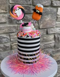 there is a cake decorated with candy and candies on top of the cake stand