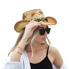 a woman wearing a cowboy hat and sunglasses