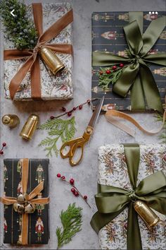 presents wrapped in wrapping paper and tied up with ribbons, bows, pine cones and bells