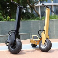 two electric scooters parked next to each other on the ground in front of a building