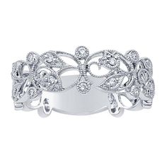 a white gold and diamond ring with leaves on the side, set in 18k white gold