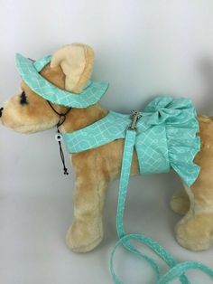 a stuffed dog wearing a hat and leash