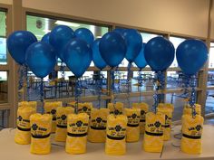 blue and yellow balloons are on display at an event