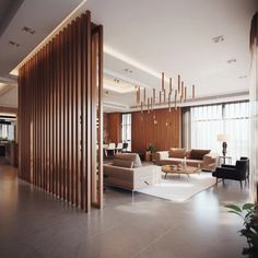 a large living room with modern furniture and wood slats