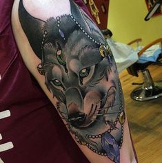 a woman with a wolf tattoo on her arm