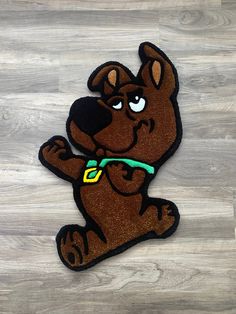 a brown dog with a green collar is sitting on the floor