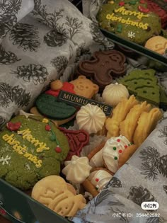 two boxes filled with assorted decorated cookies