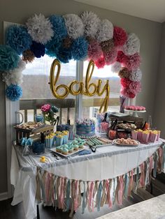 a baby shower party with cupcakes, cake and decorations