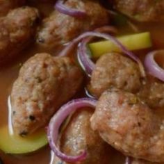 meatballs with onions and pickles on a plate