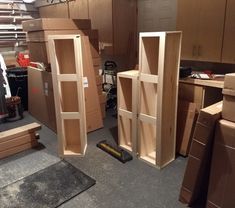 several wooden shelves in a room with boxes on the floor