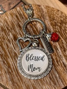 This handcrafted necklace is fondly named "Charmed Ones". This collection has numerous family/friend-themed names available (i.e., Nana, Grammaw, Gigi, Mom, etc.). Be sure to search the name you are looking for.  If you don't see the name you are looking for, it can be custom-made for you. The glass cabochon creation is set in a 25mm pendant tray and includes charms and beads that dangle from a circle connector. The necklace is a 24" long stainless steel chain. NOTE: I work with various suppliers so the style of the pendant tray, circle connector, and charms may vary depending on availability.  Like us on Facebook!  https://www.facebook.com/kkscreationsbykarens.  Also, check out my full online catalog that includes items not listed in my Etsy store.   https://kks-creations-by-karen.myshopi Themed Names, Charmed Ones, Family Friend, Handcrafted Necklace, A Circle, Steel Chain, Stainless Steel Chain, Etsy Store, Charm Necklace