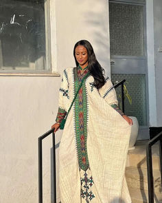 a woman is standing on the steps outside