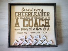 a wooden plaque that says behind every cheerleader is a coach who believe in the first